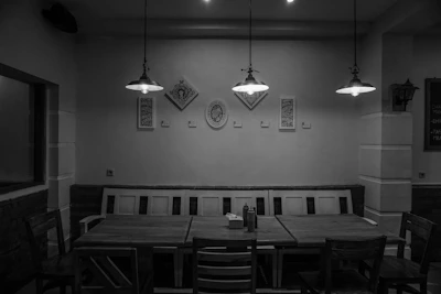Elegant dining area featuring custom wood furniture and monochrome decor in a premium interior.