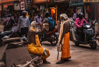 people sitting on bench near building during daytime