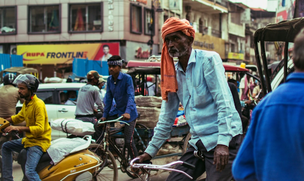 man in blue denim jacket and orange knit cap riding on yellow motorcycle during daytime