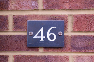 Close-up of freshly painted house numbers on a clean concrete curb.