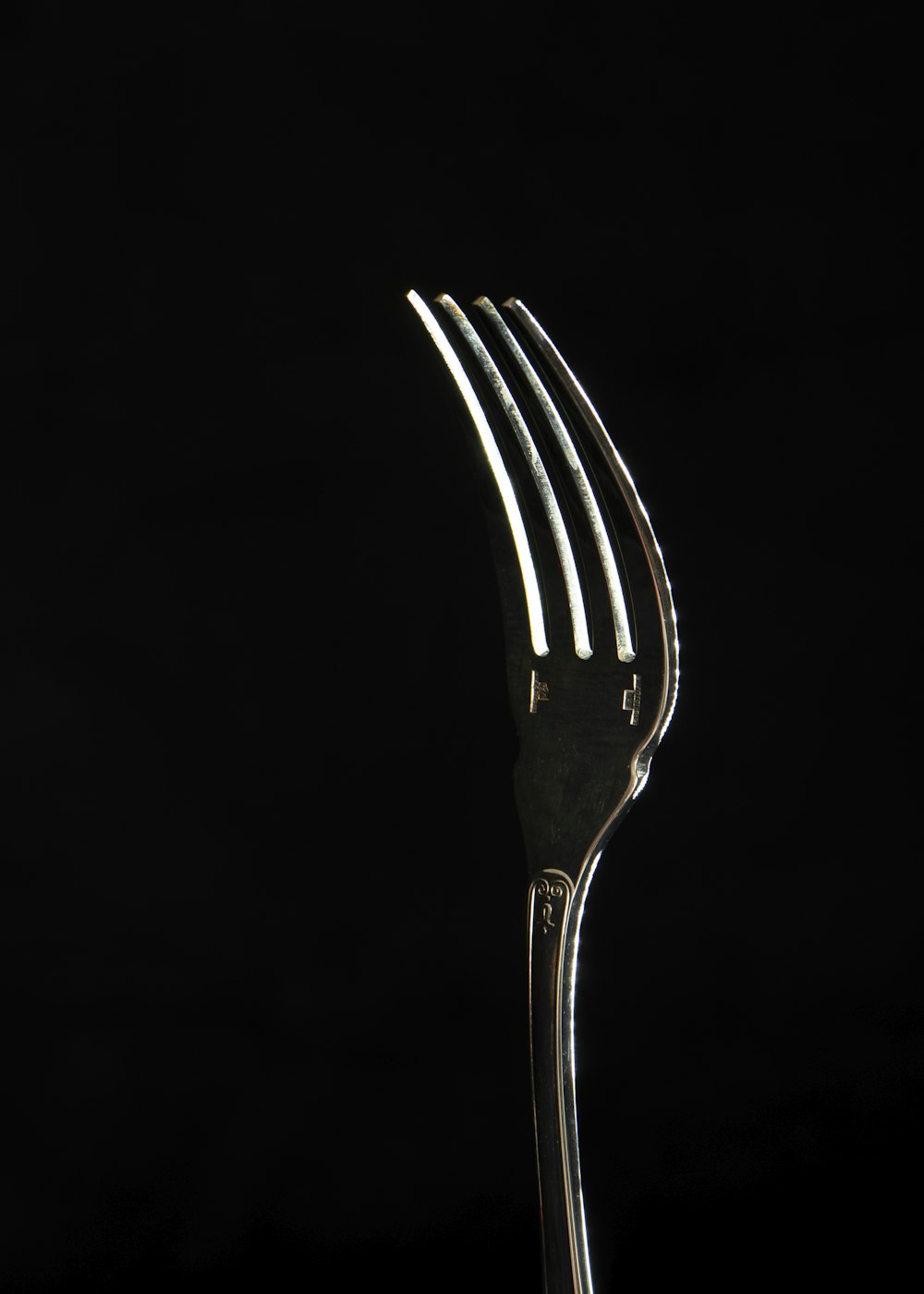 stainless steel fork with black background