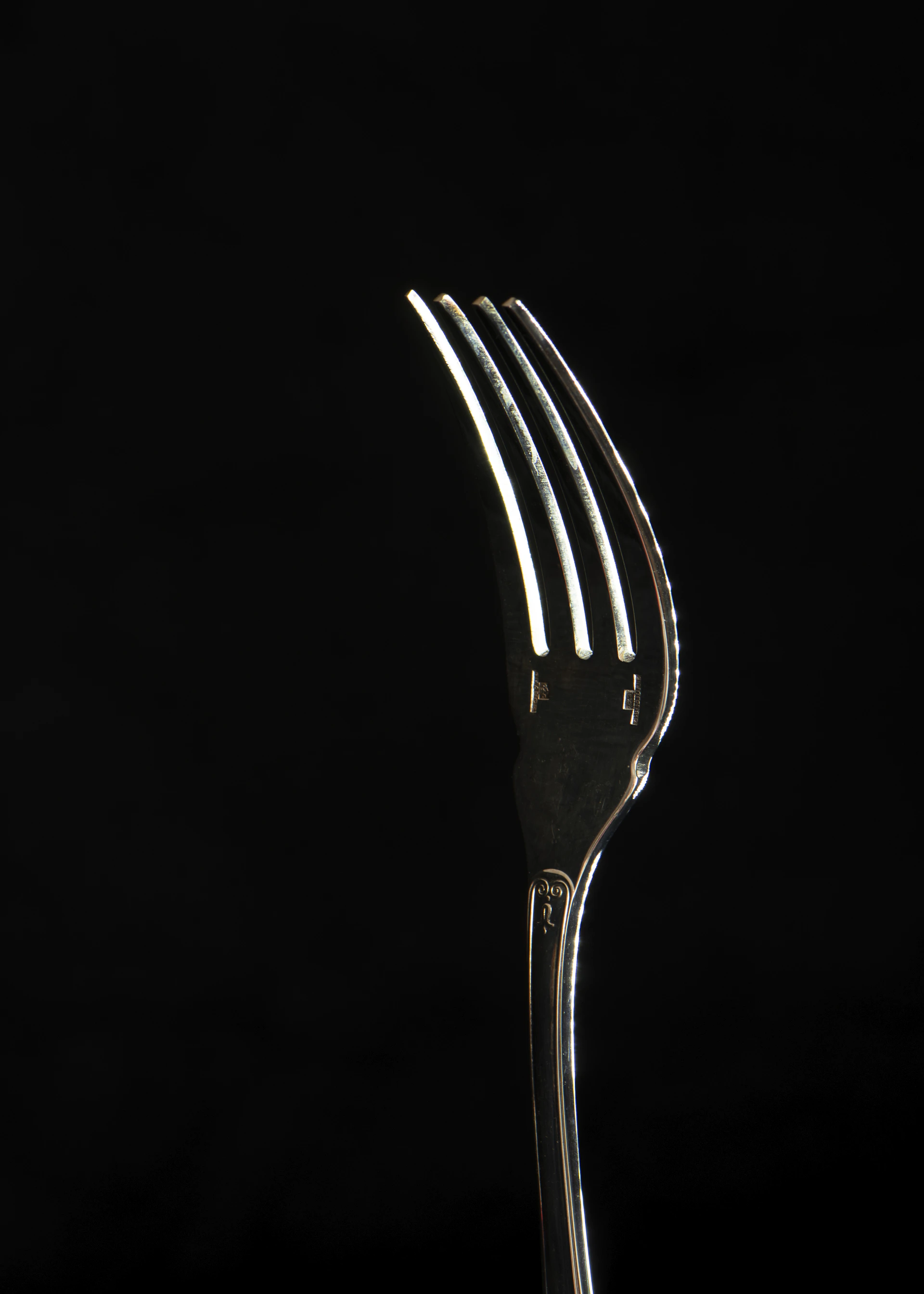 stainless steel fork with black background