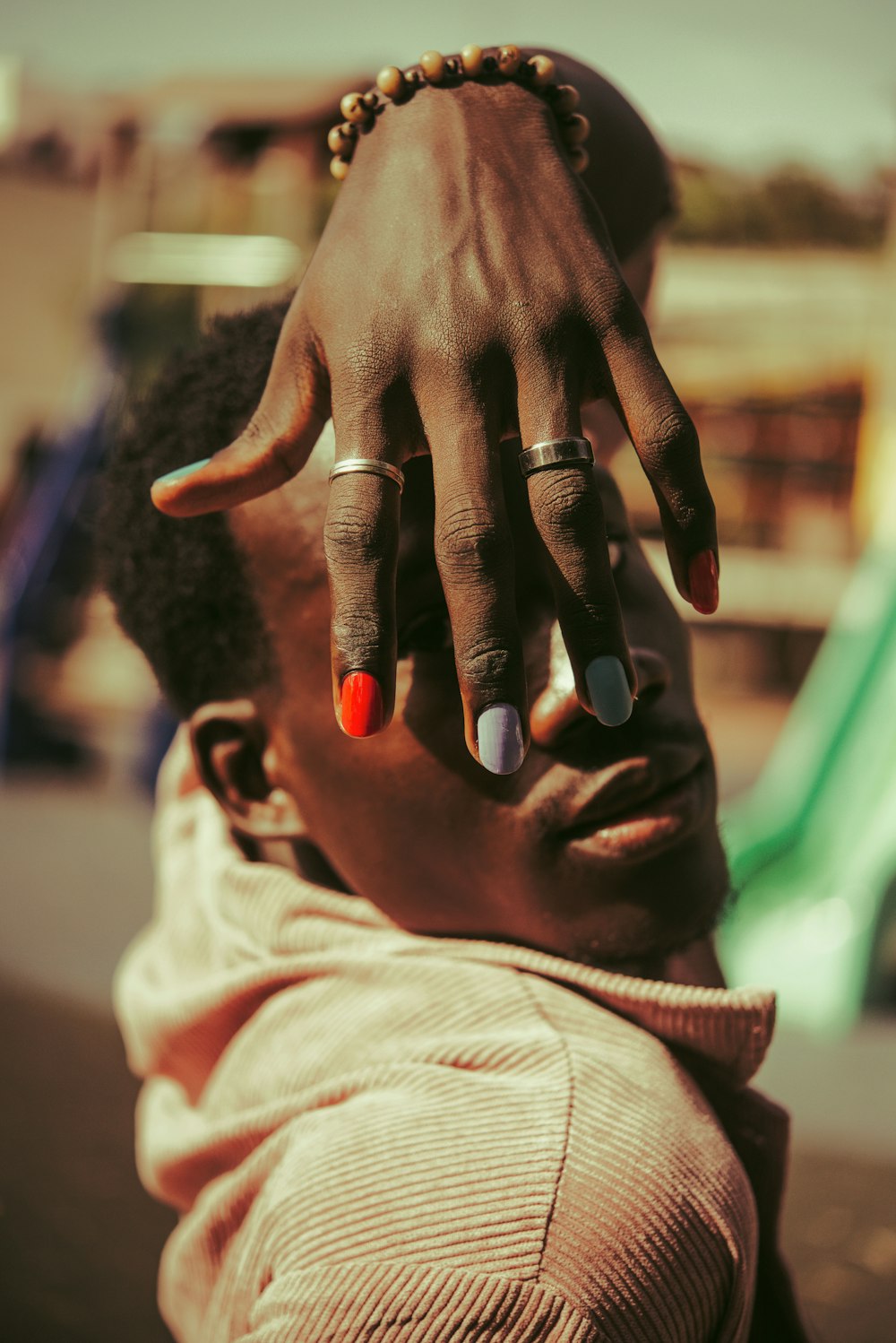 person with black manicure and silver ring