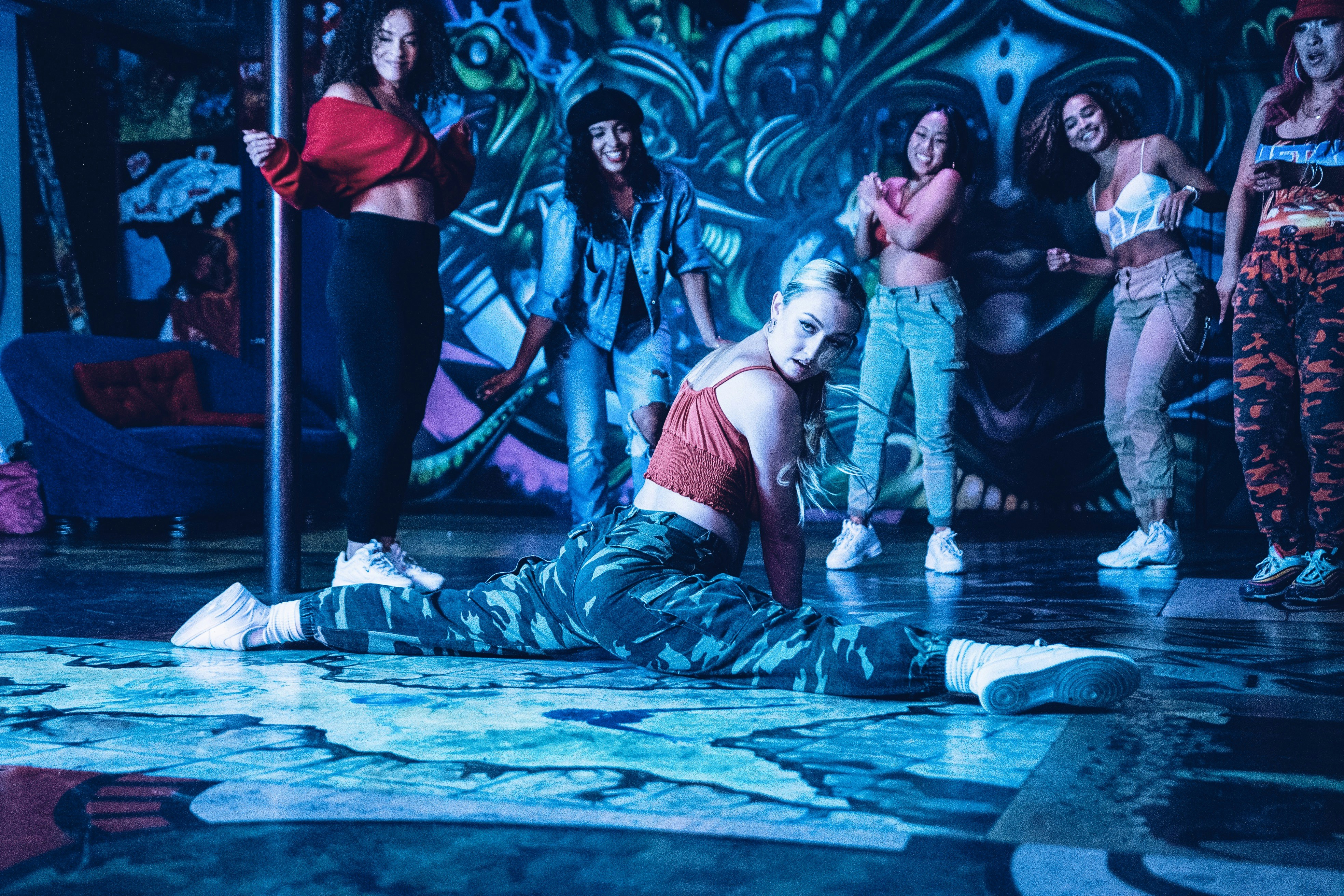 woman in blue and black dress lying on floor