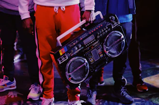 man in red jacket holding black dj controller