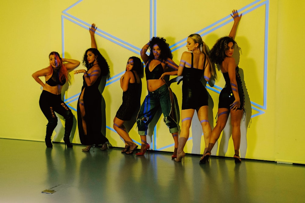 group of women in black tank top and black shorts