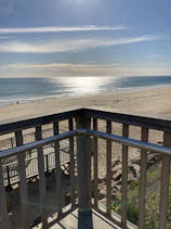 A serene beach view from the hotel balcony.