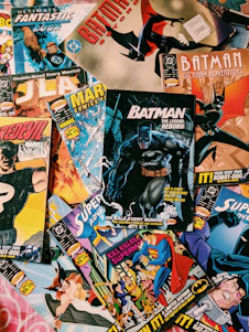A colorful spread of Inkspire comic books fanned out on a wooden table.