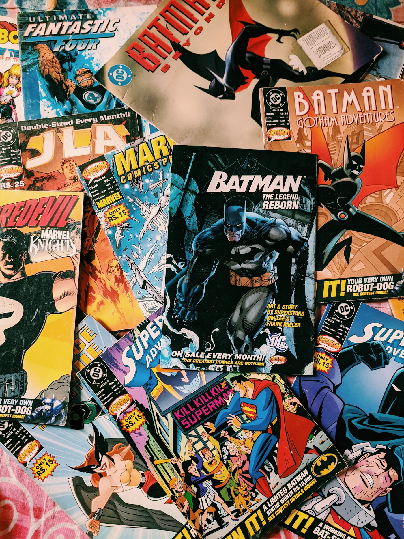 Open comic issues spread across a wooden table