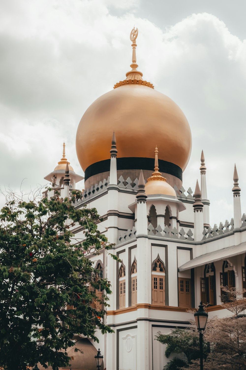 brown and white dome building under white clouds during daytime