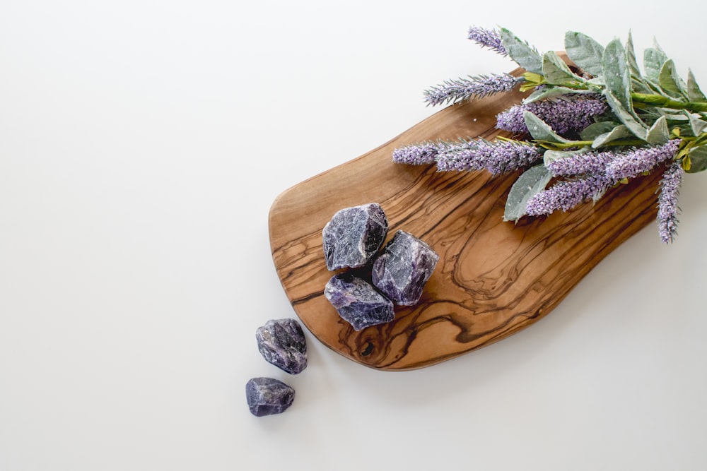 green leaves on brown wooden chopping board