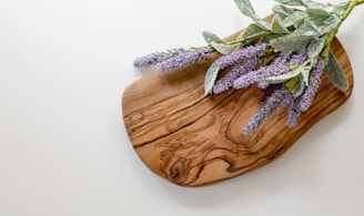green and purple leaves on brown wooden chopping board
