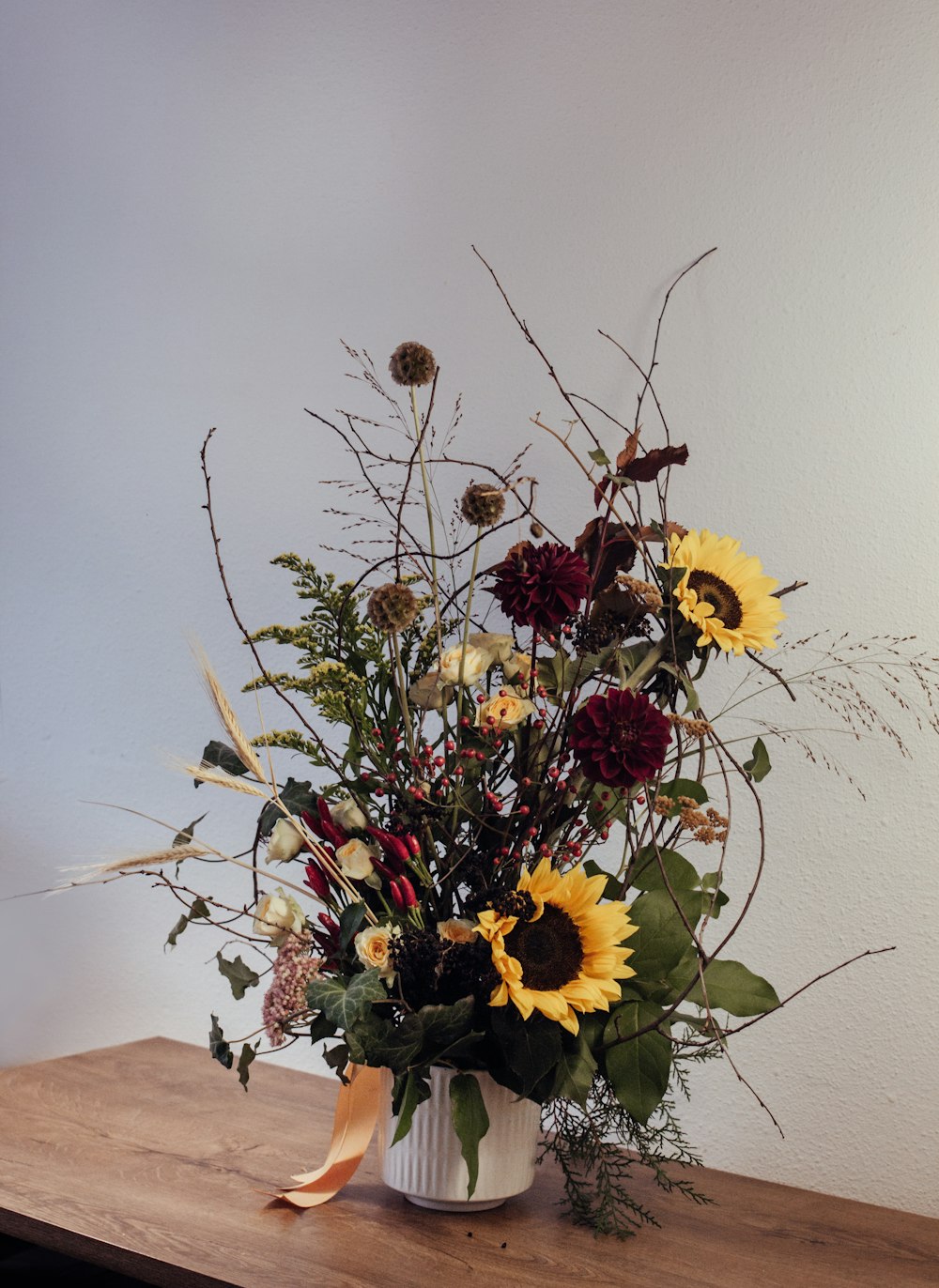 yellow sunflower on brown wooden table