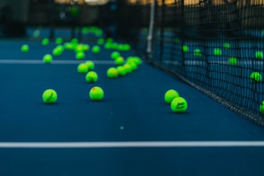 green tennis balls on tennis court