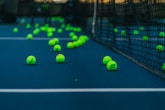 green tennis balls on tennis court