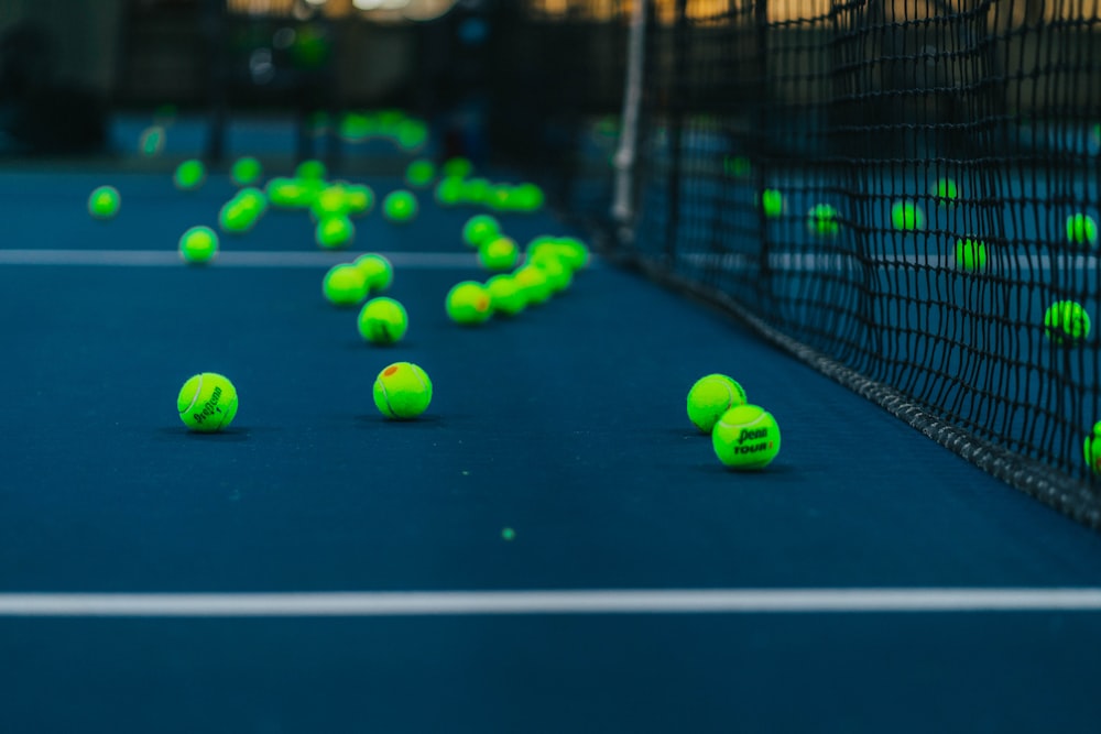 green tennis balls on tennis court