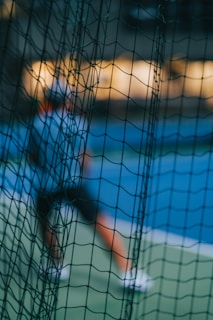 An athlete mid-stride, rim-lit in blue and purple, with subtle film grain adding cinematic depth.