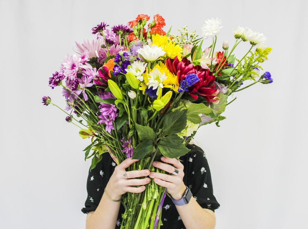 person holding bouquet of flowers