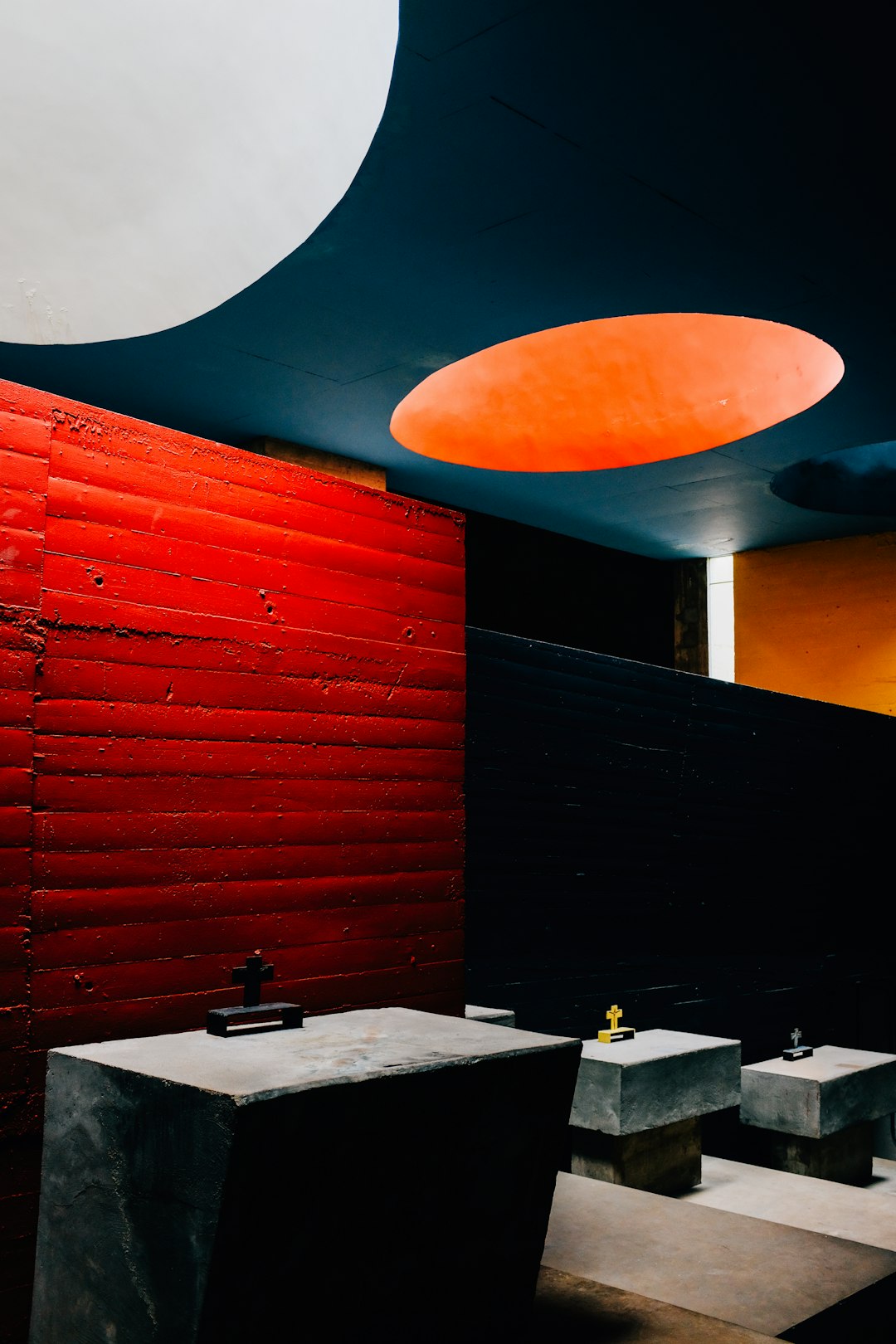 red and black wall with white ceramic sink