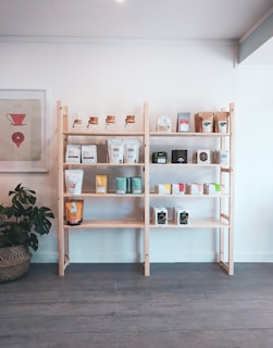 brown wooden shelf with books and figurines