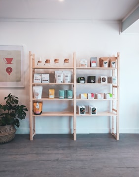 brown wooden shelf with books and figurines
