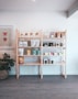 brown wooden shelf with books and figurines
