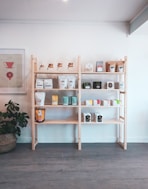 brown wooden shelf with books and figurines