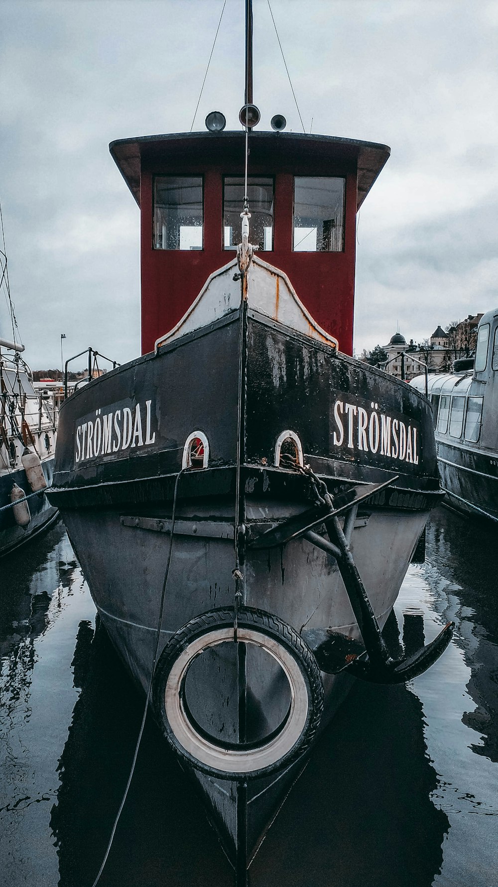 red and black ship on dock during daytime