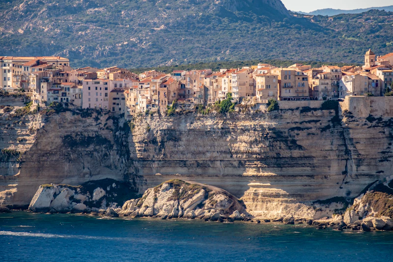 The old town of Bonifacio on white limestone cliffs above deep blue water, southern Corsica