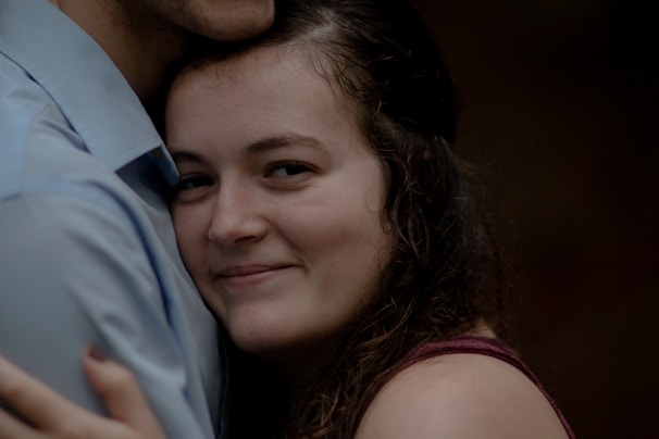 Woman smiling gently, representing empathy and support.