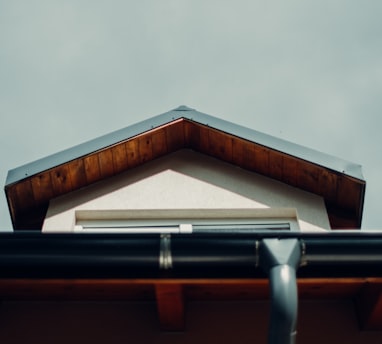 brown wooden roof under white sky during daytime