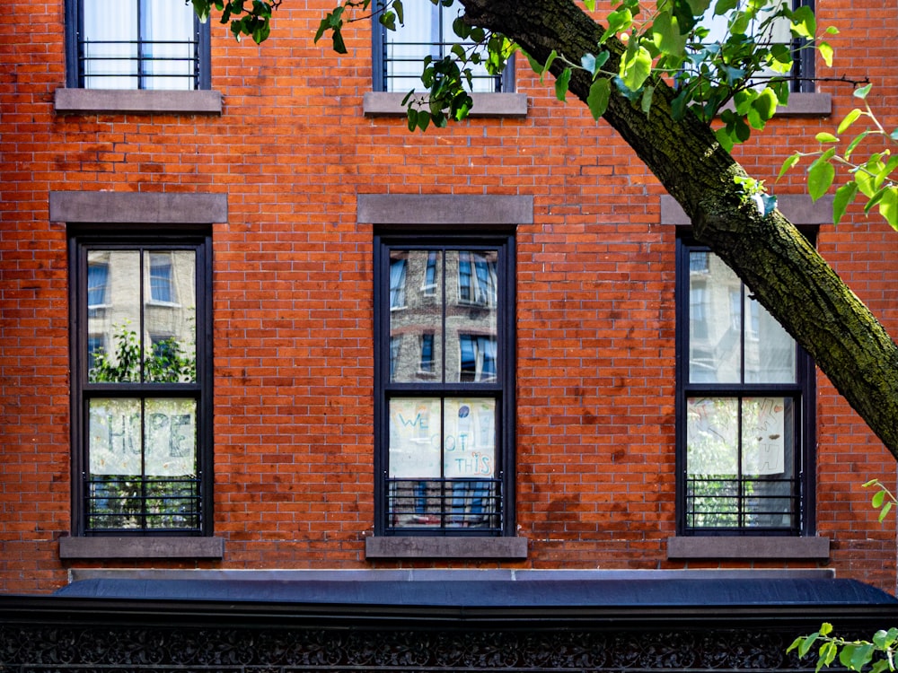 brown brick building with black framed glass window