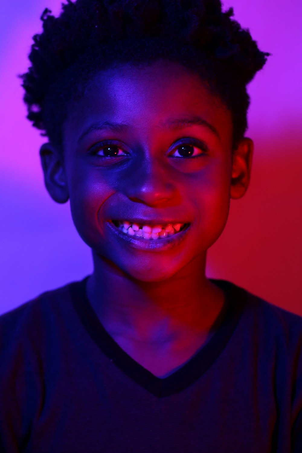 boy in black crew neck shirt smiling