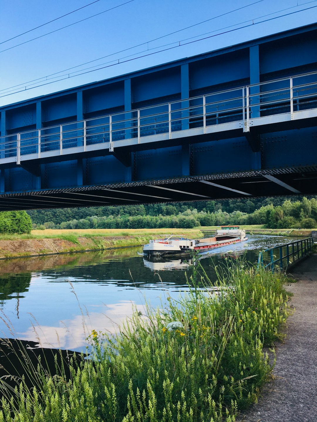 white and red boat on river under bridge during daytime