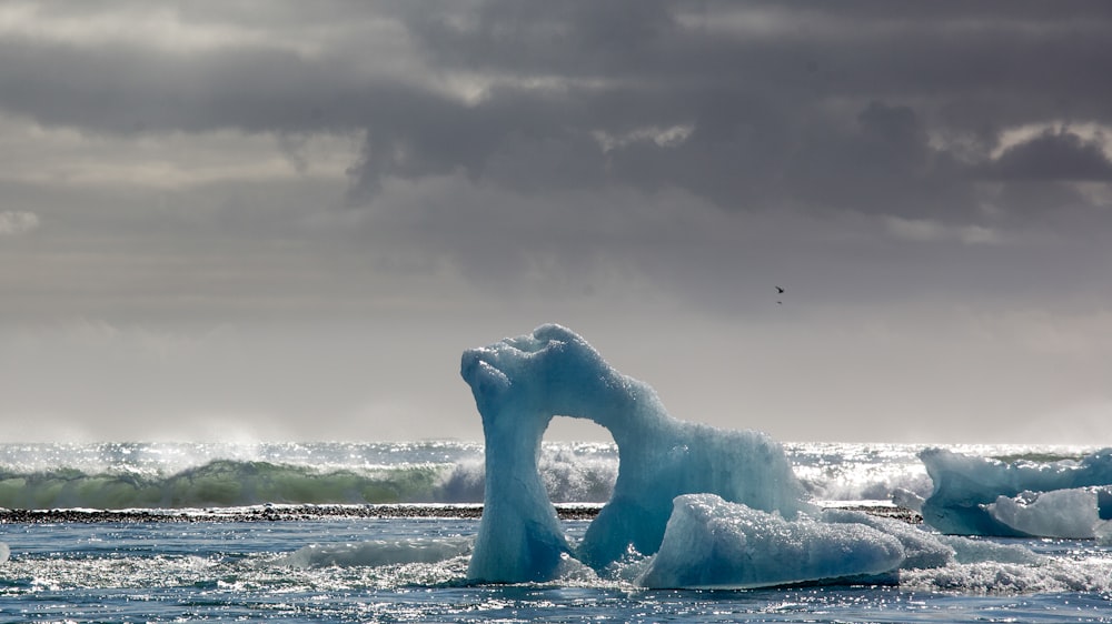 white ice formation on sea during daytime