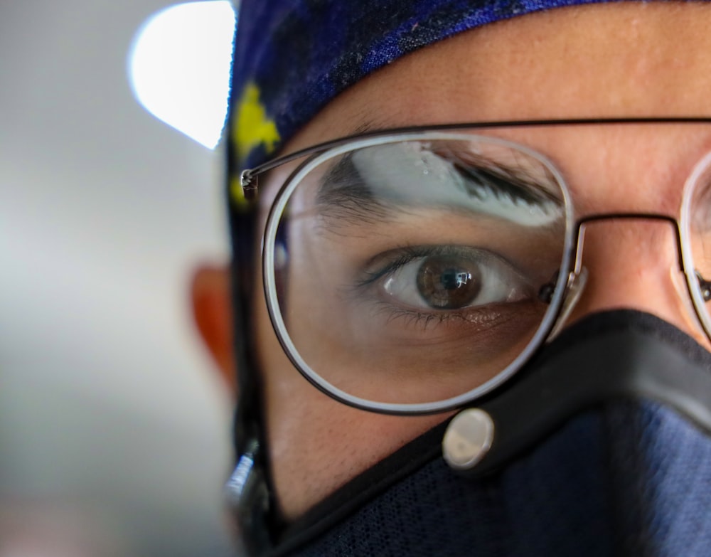 person wearing blue knit cap and black framed eyeglasses