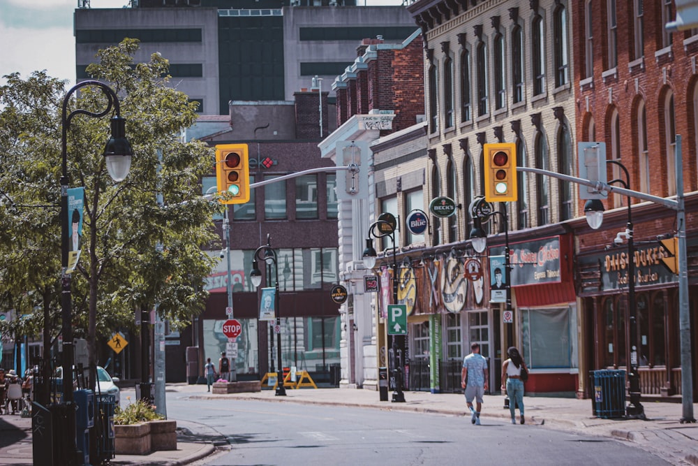 people walking on sidewalk near building during daytime