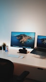 black flat screen computer monitor on white table