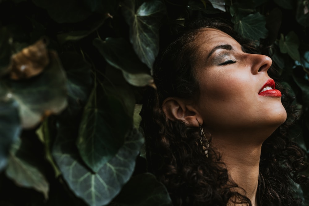 woman in black shirt near green leaves