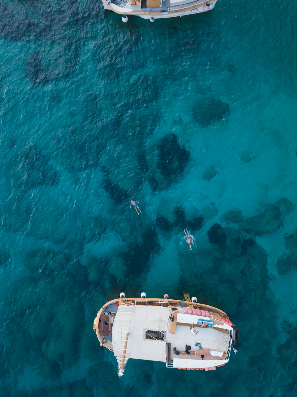 white and brown boat on body of water during daytime