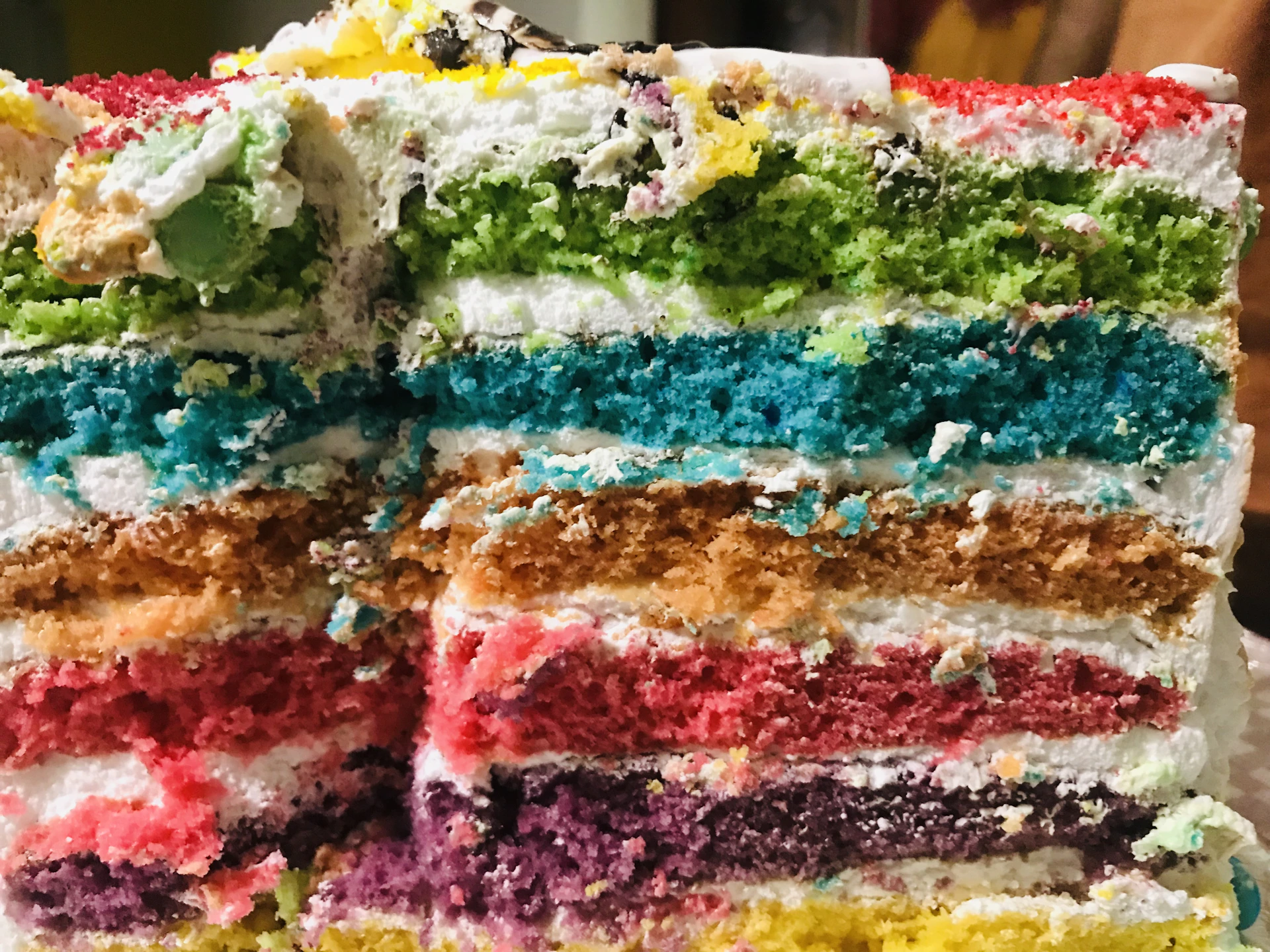 A close-up of a beautifully decorated Vietnamese pandan cake with vibrant green layers and delicate floral icing.