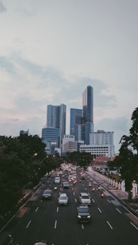 cars on road near city buildings during daytime