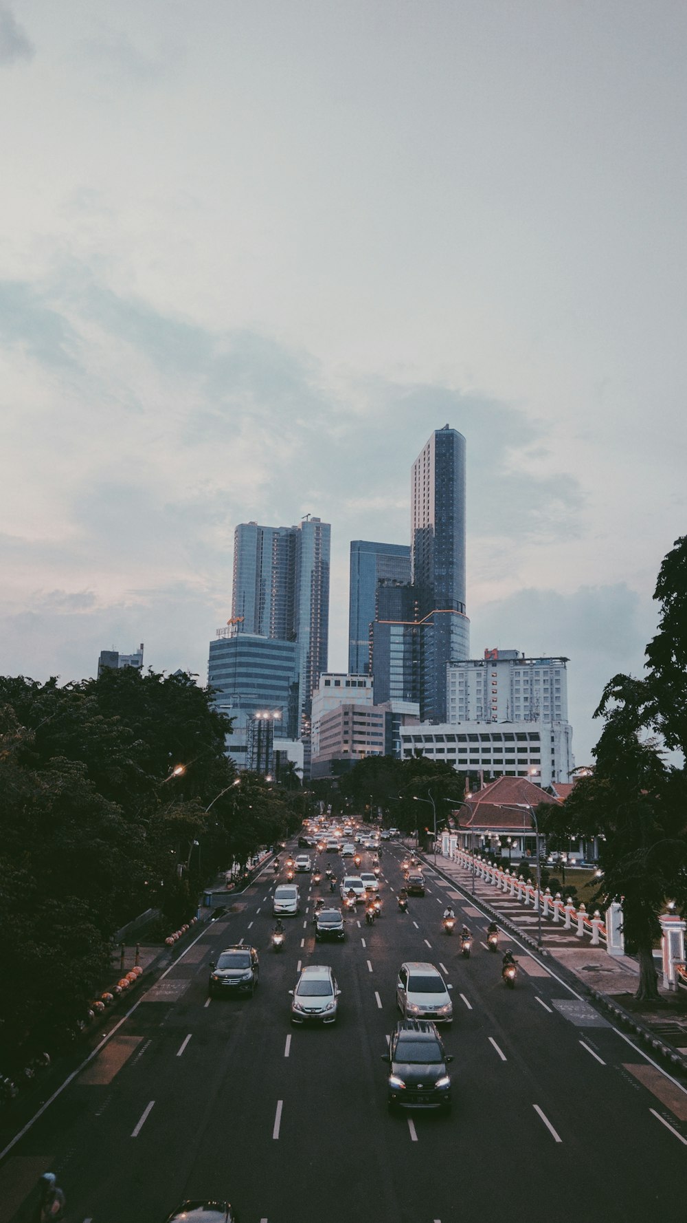 cars on road near city buildings during daytime