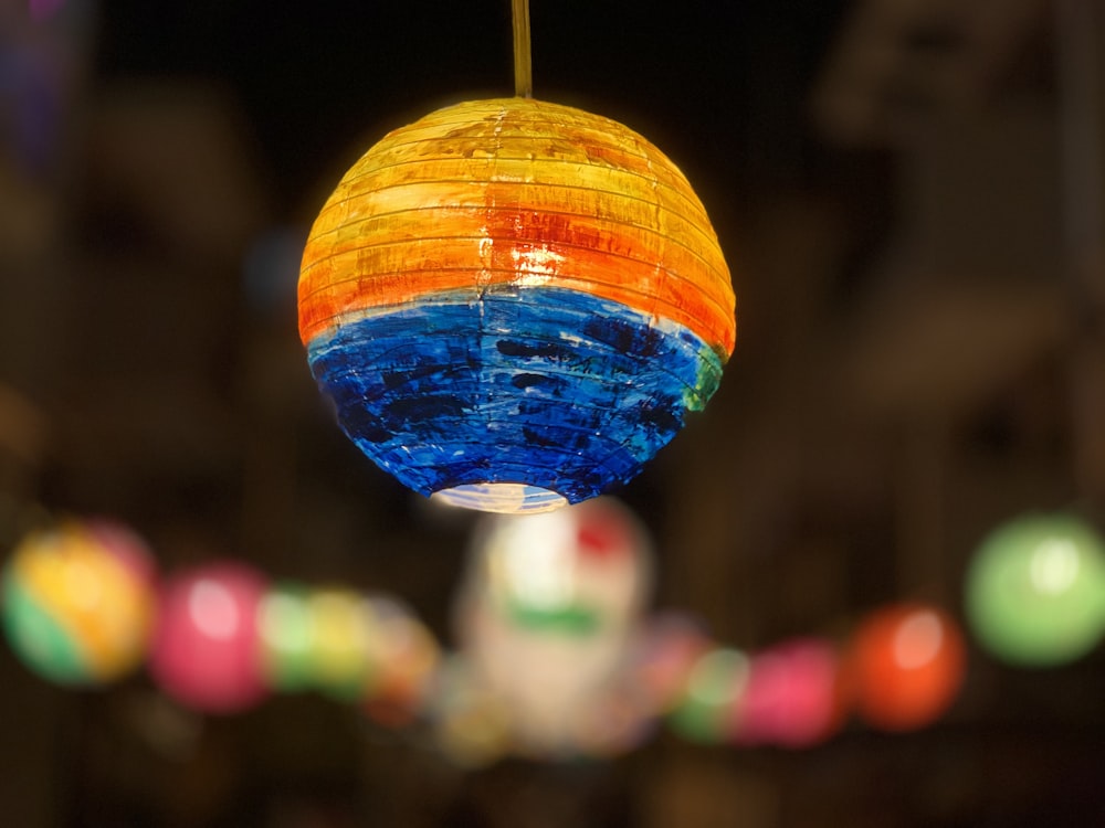 orange and blue round pendant lamp