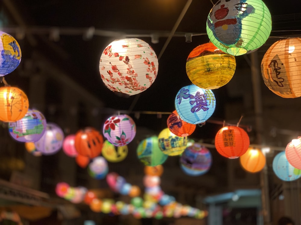 selective focus photography of assorted color hanging lanterns