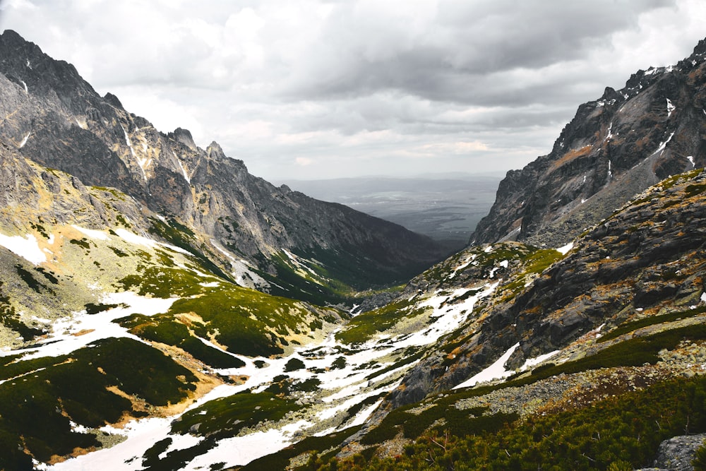 gray and green mountains under white clouds during daytime