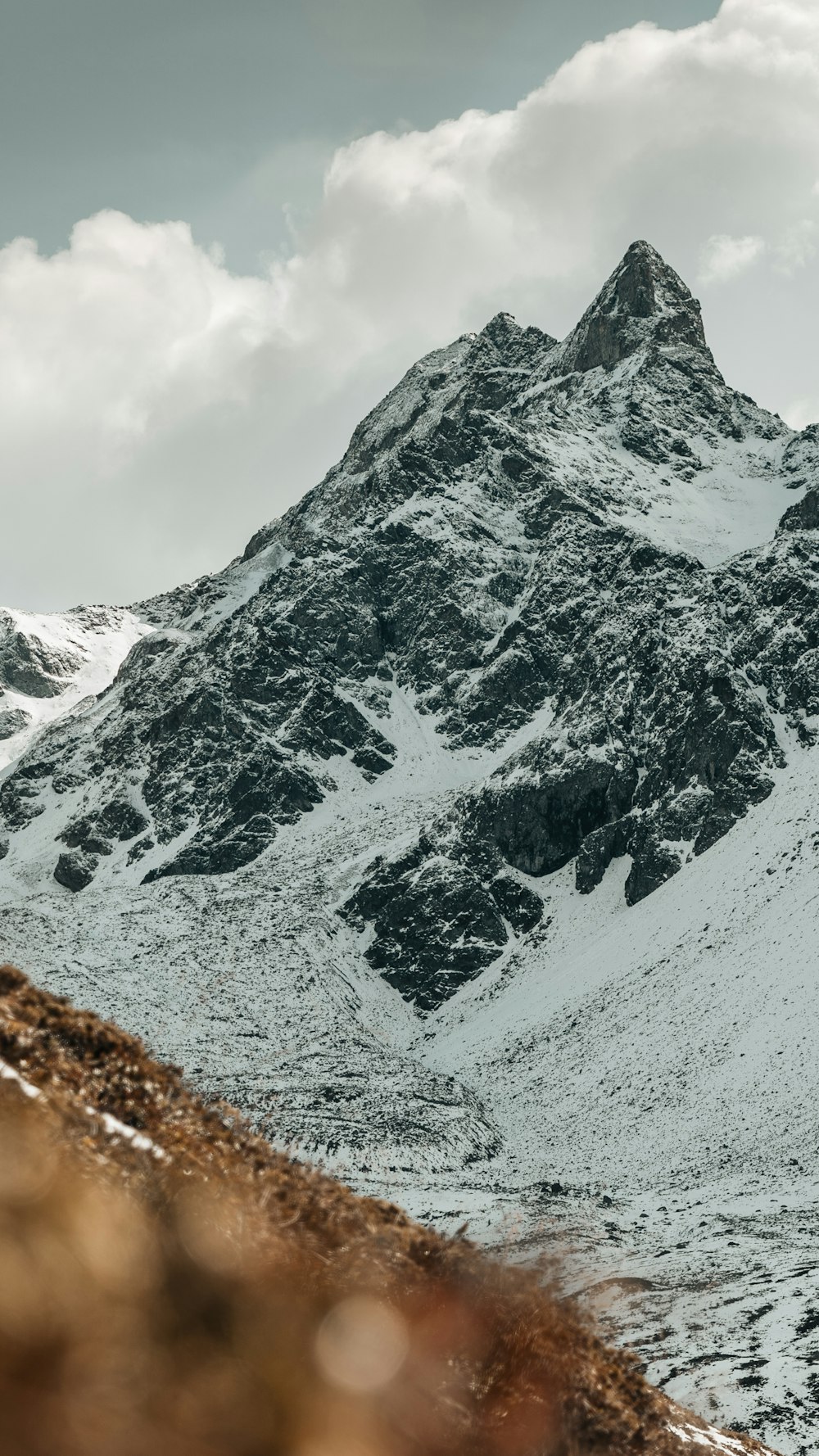 Schneebedeckter Berg tagsüber unter bewölktem Himmel