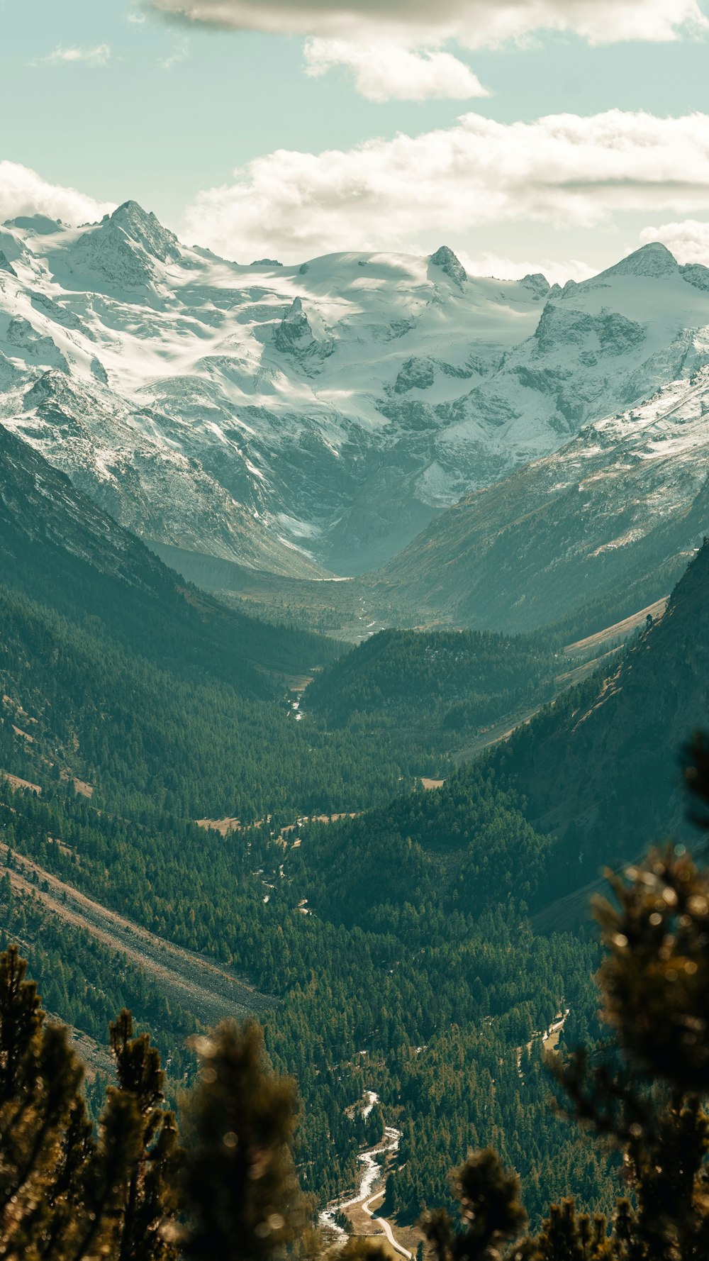 green and white mountains under white clouds during daytime