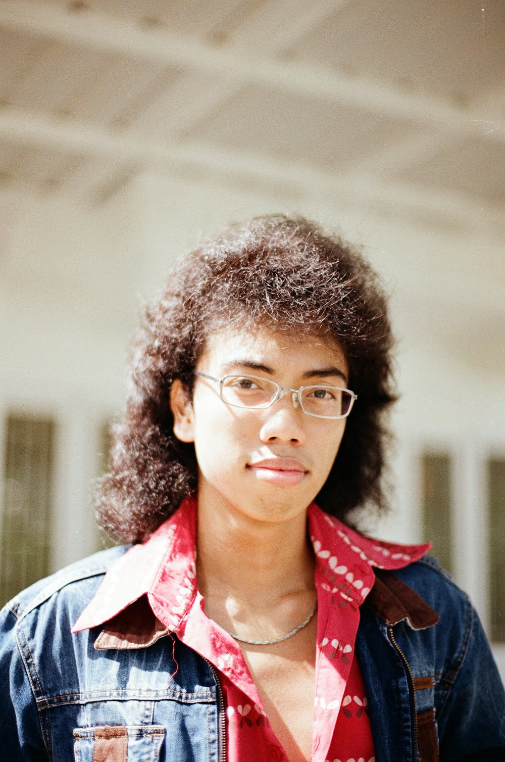 woman in blue jacket wearing eyeglasses