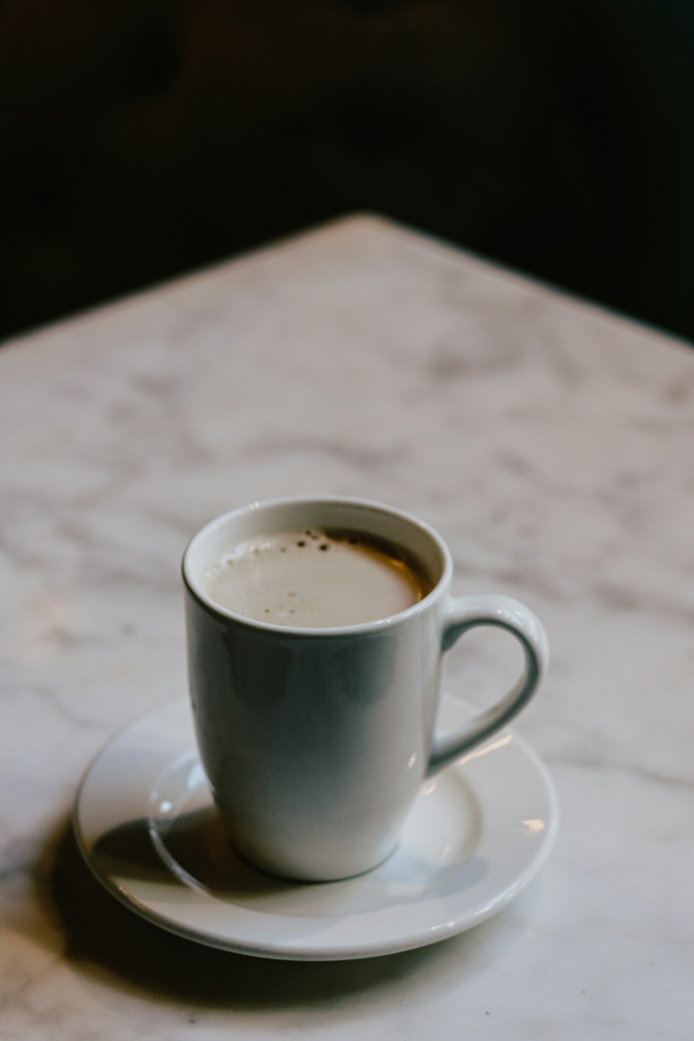 white ceramic mug on white ceramic saucer